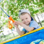 Happy Toddler boy playing with Fishing Rod