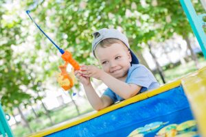 Happy Toddler boy playing with Fishing Rod